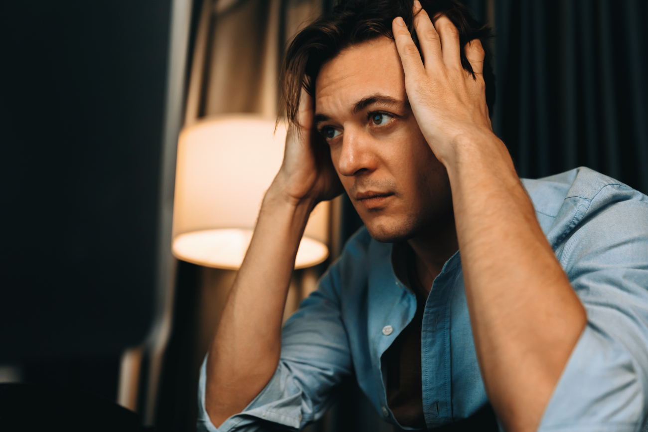 man with hands on head with eyes closed1920 1171